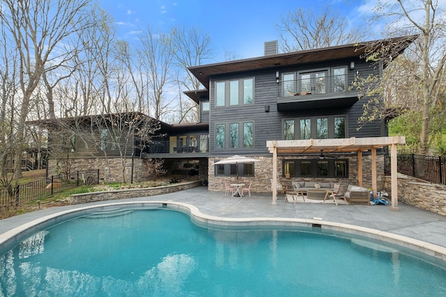 1122 Oman Dr, Brentwood, TN 37027 - back of property with a balcony, outdoor lounge area, a chimney, and a fenced backyard