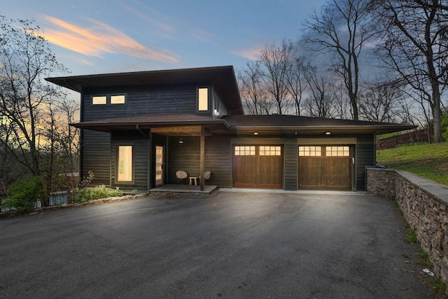 1122 Oman Dr, Brentwood, TN 37027 - contemporary house featuring asphalt driveway, covered porch, and an attached garage
