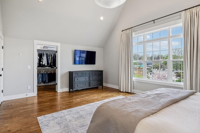 1547 Battlefield Dr, Nashville, TN 37215 - bedroom featuring a walk in closet, lofted ceiling, baseboards, a closet, and wood finished floors