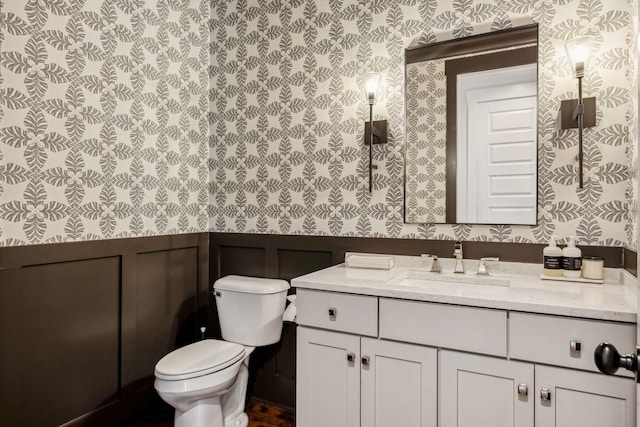 1547 Battlefield Dr, Nashville, TN 37215 - bathroom with wallpapered walls, vanity, toilet, and wainscoting