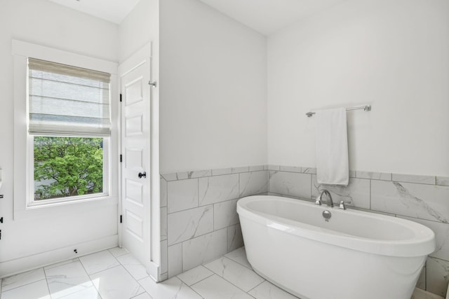 1547 Battlefield Dr, Nashville, TN 37215 - bathroom featuring wainscoting, marble finish floor, tile walls, and a freestanding bath