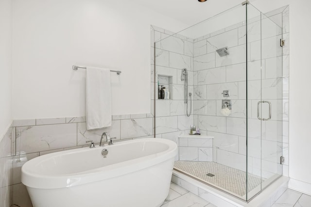 1547 Battlefield Dr, Nashville, TN 37215 - bathroom with a stall shower, a soaking tub, wainscoting, marble finish floor, and tile walls