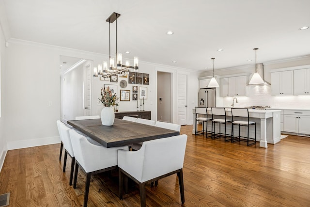 1547 Battlefield Dr, Nashville, TN 37215 - dining space with wood finished floors, baseboards, visible vents, ornamental molding, and recessed lighting