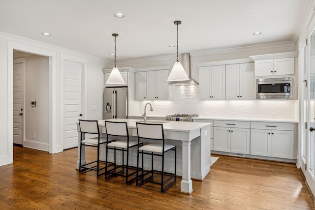 1547 Battlefield Dr, Nashville, TN 37215 - kitchen with an island with sink, light countertops, wall chimney exhaust hood, a kitchen bar, and appliances with stainless steel finishes