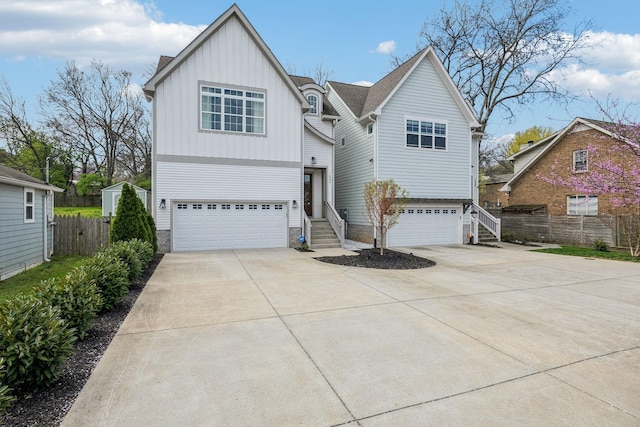 1547 Battlefield Dr, Nashville, TN 37215 - view of front facade featuring board and batten siding, concrete driveway, fence, and an attached garage