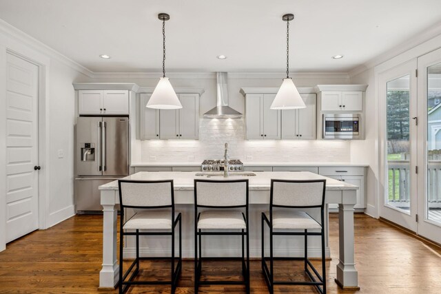 1547 Battlefield Dr, Nashville, TN 37215 - kitchen with a wealth of natural light, appliances with stainless steel finishes, an island with sink, and wall chimney exhaust hood