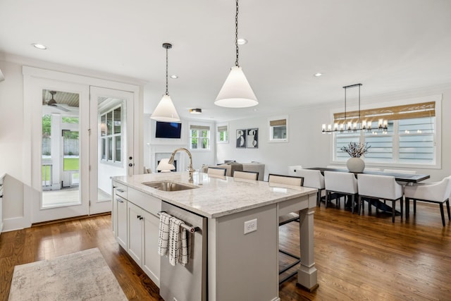 1547 Battlefield Dr, Nashville, TN 37215 - kitchen featuring a sink, a breakfast bar area, dishwasher, dark wood finished floors, and hanging light fixtures