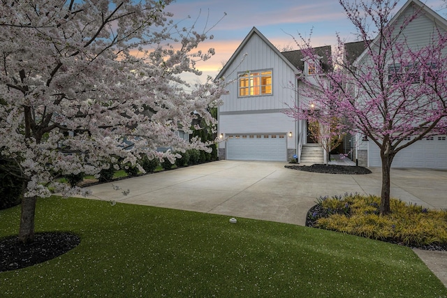 1547 Battlefield Dr, Nashville, TN 37215 - view of front facade featuring driveway, a garage, board and batten siding, and a yard