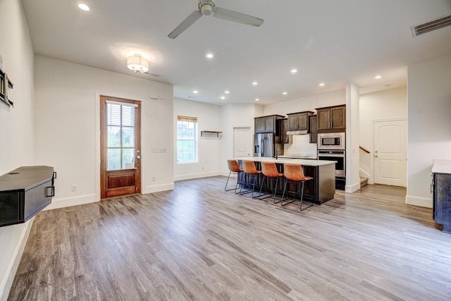 1006 Chisolm Trl, Goodlettsville, TN 37072 - kitchen featuring a kitchen island with sink, stainless steel appliances, light wood finished floors, and visible vents