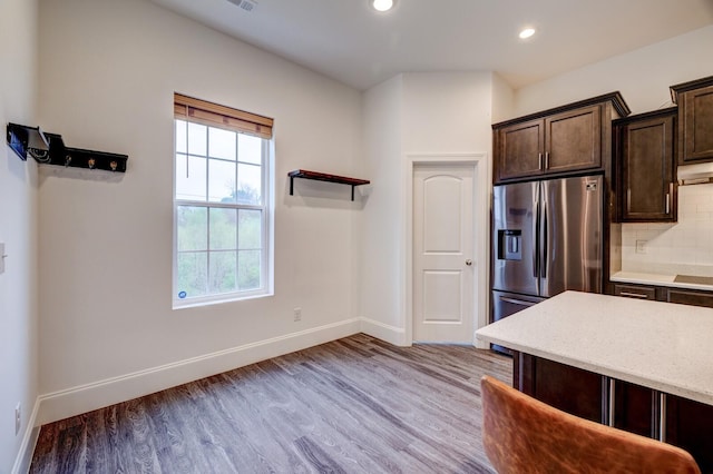 1006 Chisolm Trl, Goodlettsville, TN 37072 - kitchen featuring tasteful backsplash, recessed lighting, light wood-type flooring, stainless steel fridge with ice dispenser, and dark brown cabinets