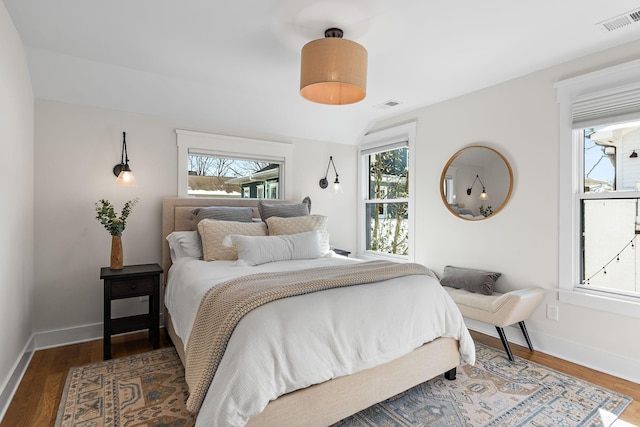 920A Kirkwood Ave, Nashville, TN 37204 - bedroom featuring wood finished floors, baseboards, multiple windows, and visible vents