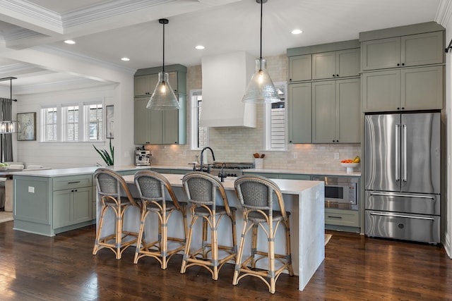 920A Kirkwood Ave, Nashville, TN 37204 - kitchen featuring light countertops, appliances with stainless steel finishes, premium range hood, a center island with sink, and dark wood-style floors