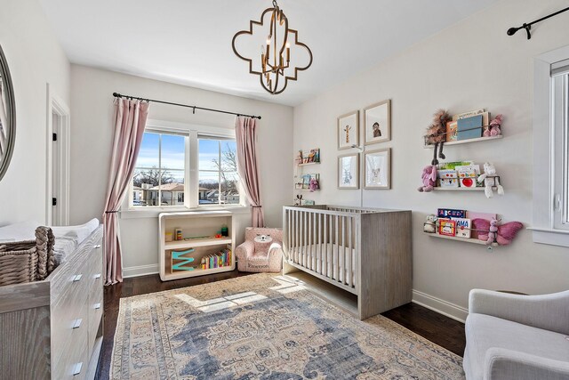 920A Kirkwood Ave, Nashville, TN 37204 - bedroom featuring baseboards, wood finished floors, an inviting chandelier, and a nursery area