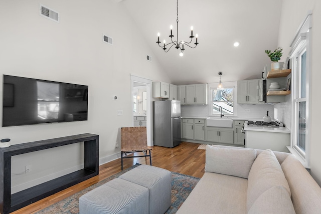 920A Kirkwood Ave, Nashville, TN 37204 - living area featuring baseboards, visible vents, a chandelier, and wood finished floors