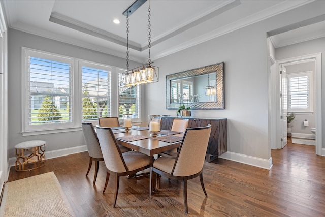 dining area featuring wood finished floors, a tray ceiling, crown molding, baseboards, and recessed lighting