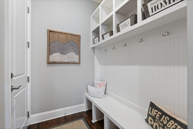 mudroom with dark wood-style flooring and baseboards