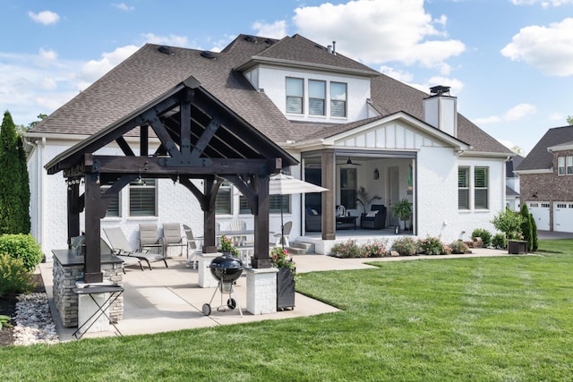 back of property featuring a gazebo, a ceiling fan, roof with shingles, and a lawn