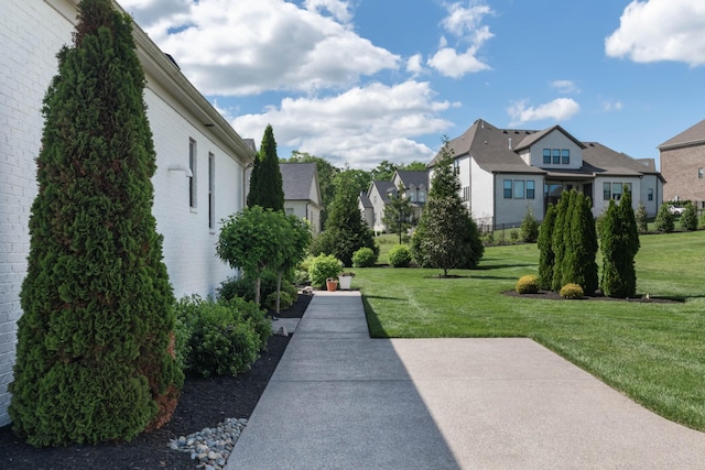 view of home's community featuring a residential view and a yard