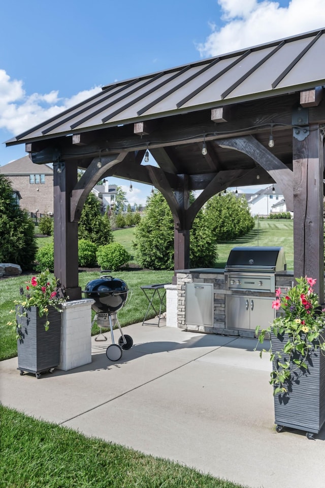 view of patio / terrace with a grill, an outdoor kitchen, and a gazebo
