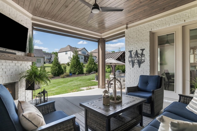 view of patio / terrace featuring an outdoor living space with a fireplace, a residential view, and ceiling fan