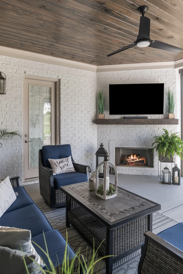 living room with wooden ceiling, a brick fireplace, and a ceiling fan
