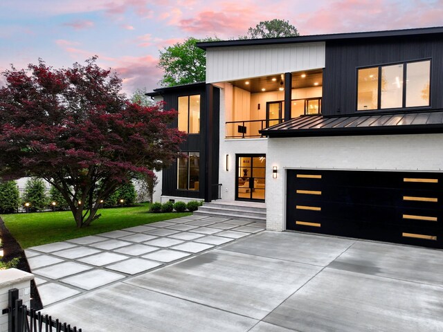 3848 Granny White Pike, Nashville, TN 37204 - modern home with a standing seam roof, a balcony, driveway, metal roof, and a yard
