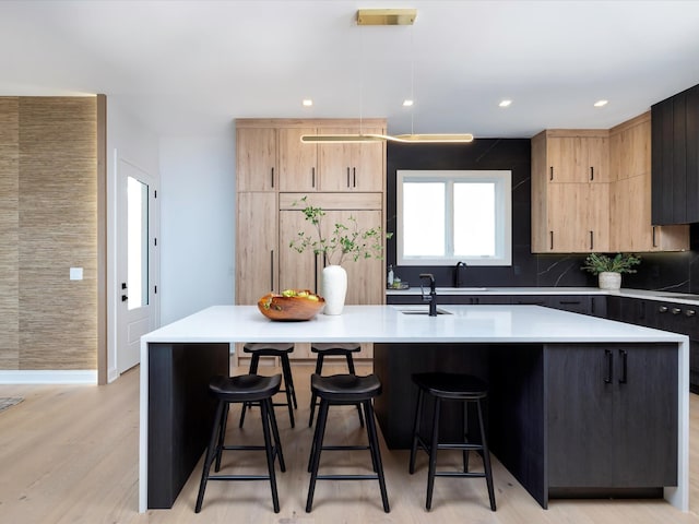 3848 Granny White Pike, Nashville, TN 37204 - kitchen featuring light brown cabinets, a center island with sink, a breakfast bar area, and recessed lighting