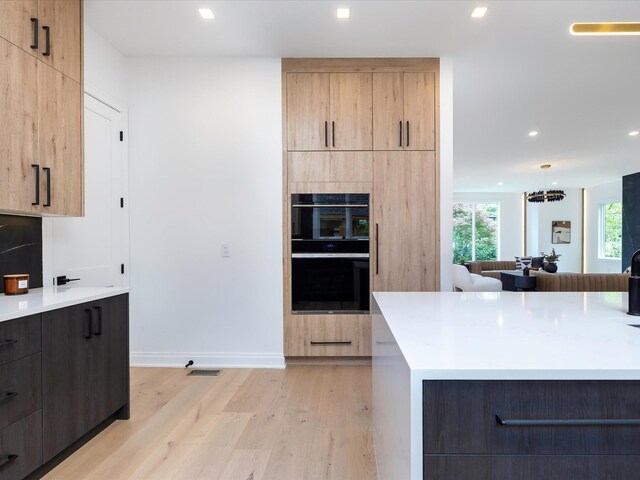 3848 Granny White Pike, Nashville, TN 37204 - kitchen featuring modern cabinets, light wood-style floors, light brown cabinets, recessed lighting, and light countertops