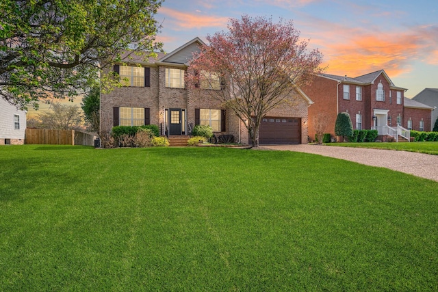133 Grove Ln S, Hendersonville, TN 37075 - view of front of house featuring driveway, a front yard, brick siding, a garage, and fence