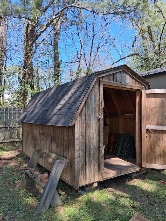 view of shed featuring fence