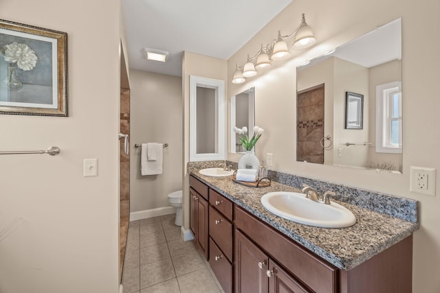 full bath featuring toilet, double vanity, a sink, and tile patterned flooring