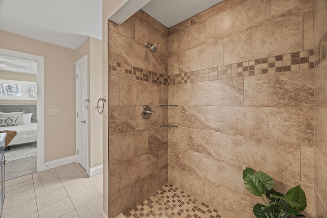 full bath with tile patterned floors, ensuite bathroom, baseboards, and a tile shower
