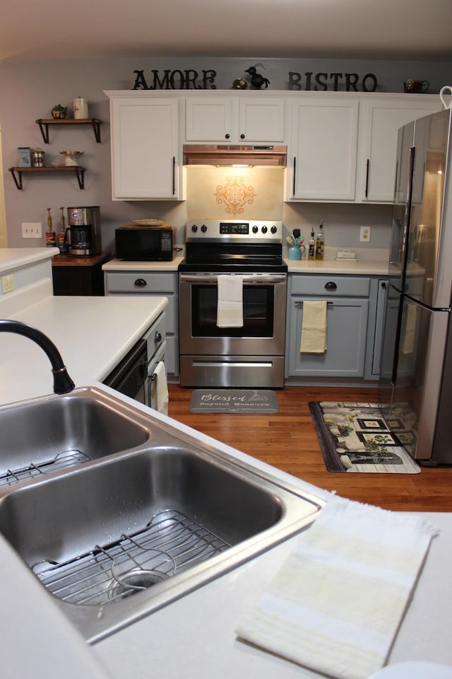 6309 Paddington Way, Antioch, TN 37013 - kitchen featuring white cabinets, a sink, light countertops, appliances with stainless steel finishes, and under cabinet range hood
