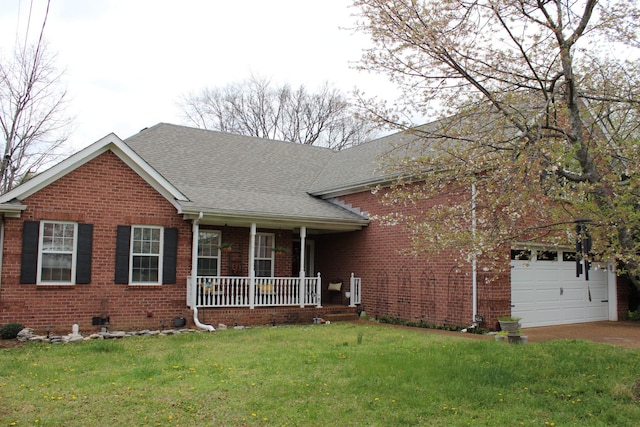 6309 Paddington Way, Antioch, TN 37013 - view of front facade with driveway, a front lawn, brick siding, a porch, and a garage