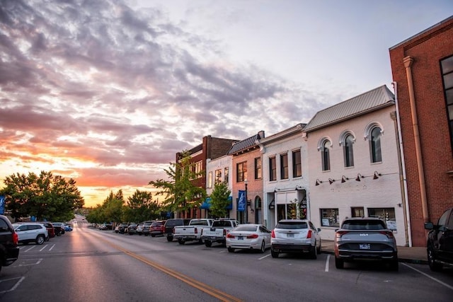 property at dusk featuring uncovered parking