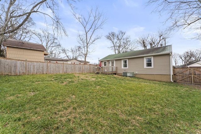 view of yard with a fenced backyard, central air condition unit, a wooden deck, and a gate