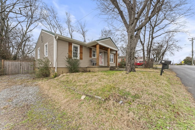 view of front of home with driveway and fence