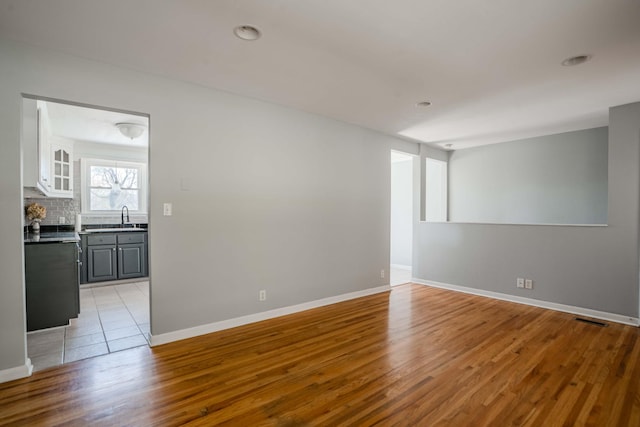 6004 Hawkdale Dr, Nashville, TN 37211 - unfurnished room featuring baseboards, visible vents, wood finished floors, and a sink