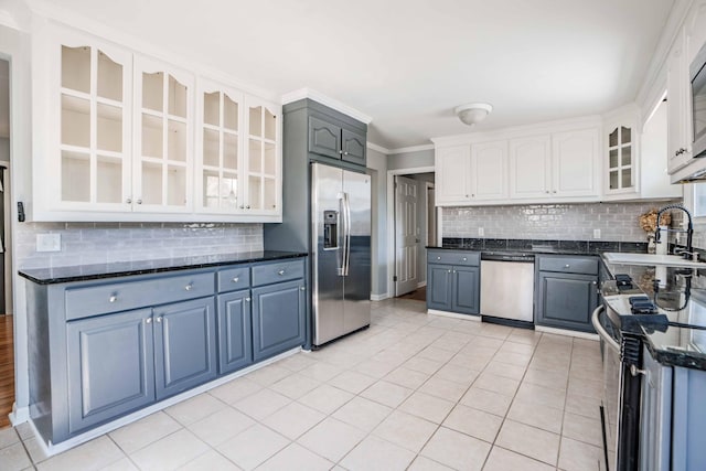 6004 Hawkdale Dr, Nashville, TN 37211 - kitchen featuring crown molding, appliances with stainless steel finishes, glass insert cabinets, a sink, and backsplash