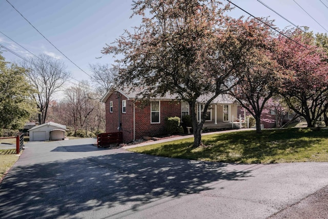 6004 Hawkdale Dr, Nashville, TN 37211 - view of front of property with brick siding, an outbuilding, a front lawn, and a detached garage