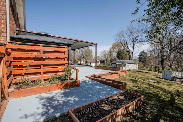 6004 Hawkdale Dr, Nashville, TN 37211 - view of yard featuring a garden, an outbuilding, and a shed