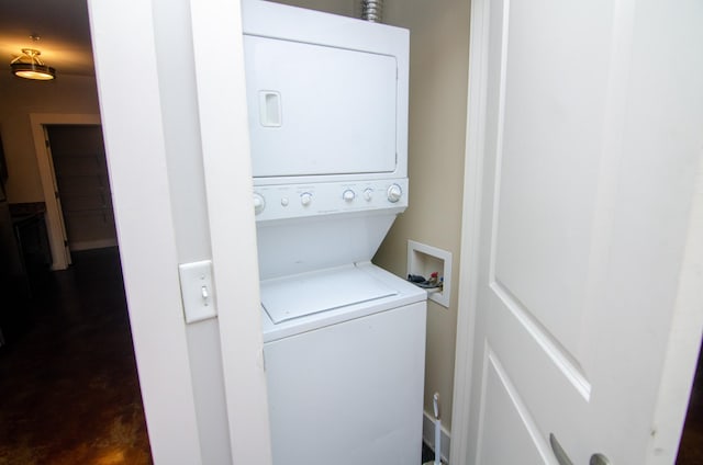 clothes washing area featuring laundry area and stacked washing maching and dryer