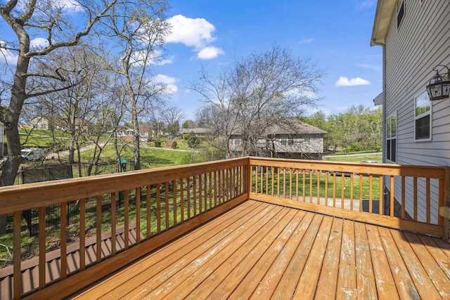 wooden deck featuring a lawn