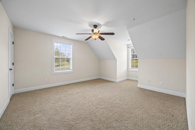 additional living space with visible vents, carpet flooring, and a healthy amount of sunlight