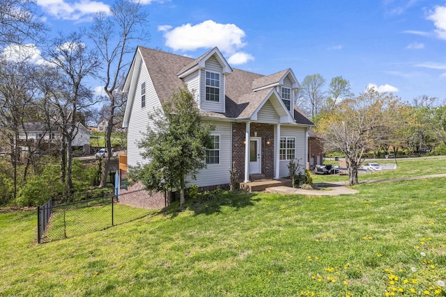 cape cod-style house with a shingled roof, a front yard, fence, and brick siding