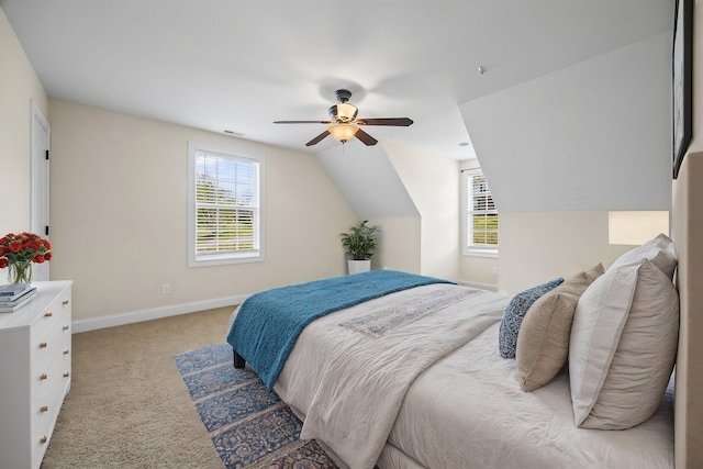 bedroom with visible vents, baseboards, a ceiling fan, light carpet, and vaulted ceiling
