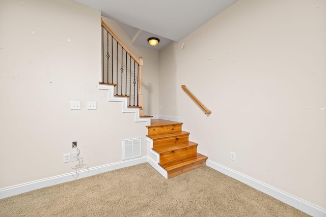 stairs with carpet, baseboards, and visible vents
