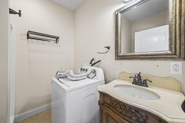 bathroom with tile patterned flooring, vanity, washer / dryer, and baseboards