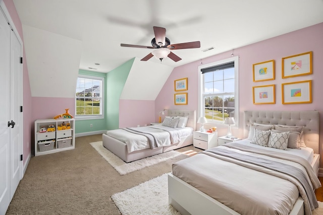 carpeted bedroom with vaulted ceiling, baseboards, visible vents, a ceiling fan, and a closet