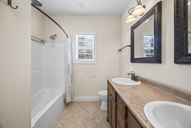 bathroom with baseboards, a sink, tile patterned floors, and toilet